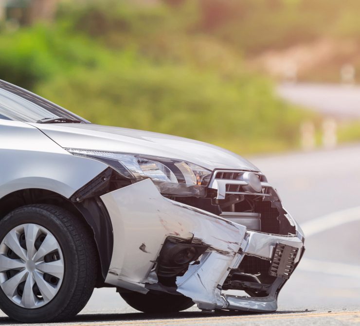 Front of silver car get damaged by crash accident on the road.